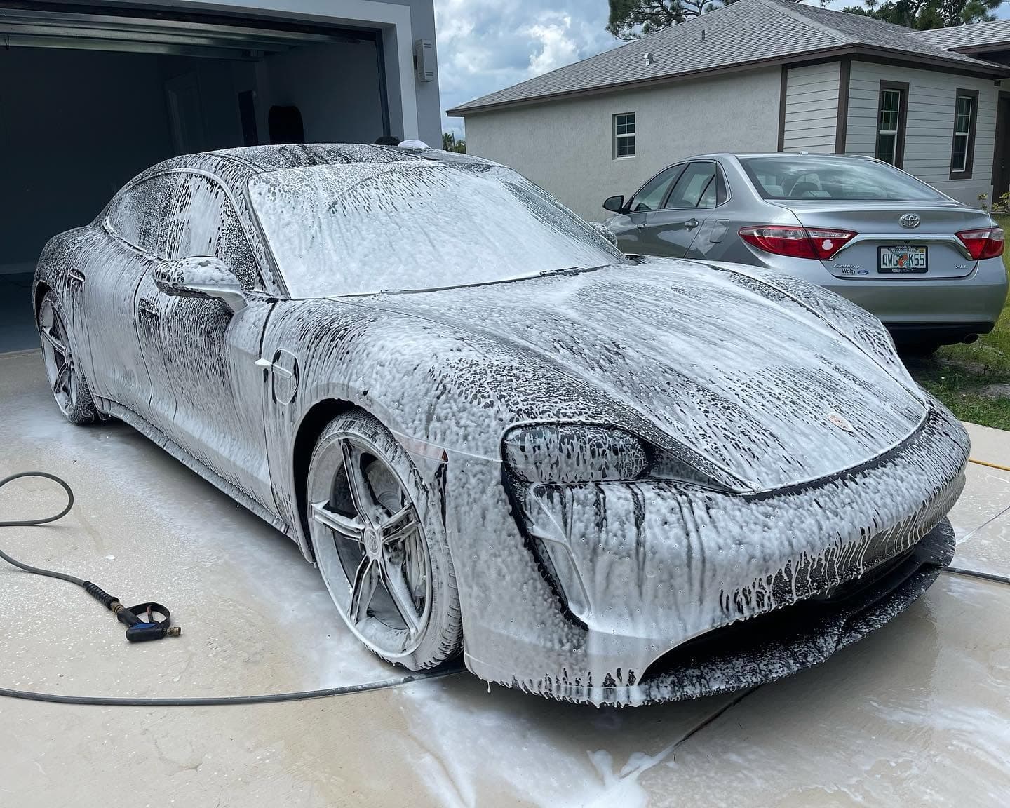Vehicle covered in foam during a mobile wash